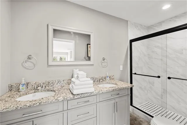 a bathroom with a sink toilet and shower