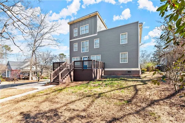 a view of a house with wooden deck