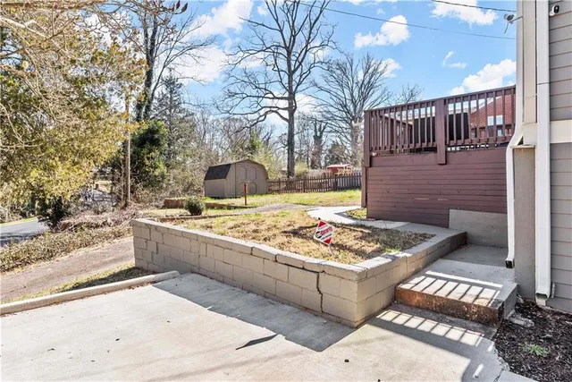 a view of balcony with wooden floor and fence
