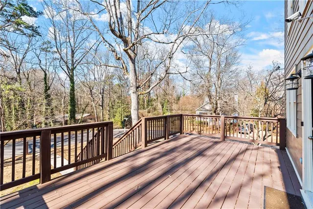 a view of balcony with wooden floor and fence