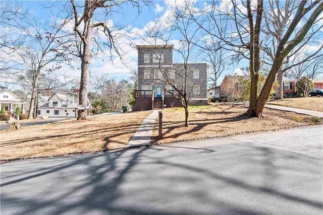 a view of a house with snow on the road
