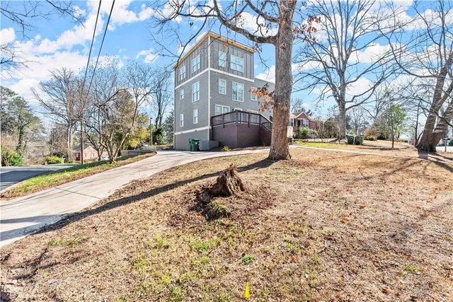 a view of a white house with a yard covered in snow