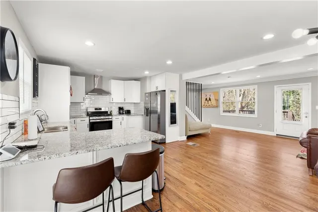 a kitchen with a stove a sink and a refrigerator