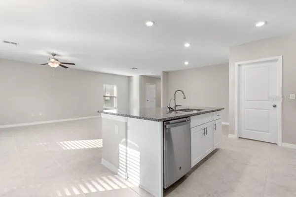 a kitchen with stainless steel appliances granite countertop a sink and stove