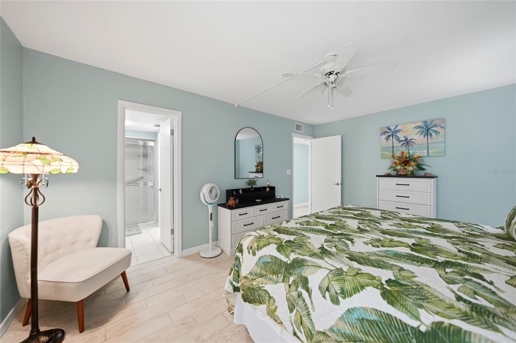 1 Colony Point Drive, Unit A10 Punta Gorda, FL 33950 - Photo 23 of 31 a bedroom with a bed and a chandelier