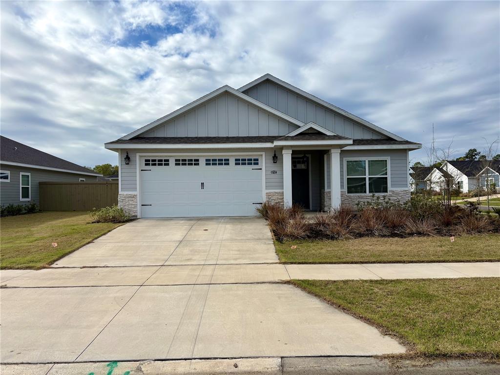 6737 Southwest 13th Lane Gainesville, FL 32607 - Photo 1 of 24 a front view of a house with garden
