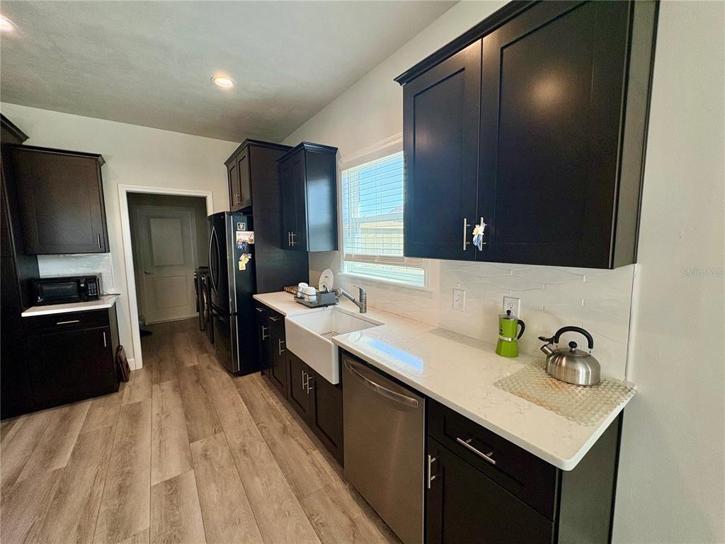 6737 Southwest 13th Lane Gainesville, FL 32607 - Photo 13 of 24 a kitchen with a sink appliances and cabinets