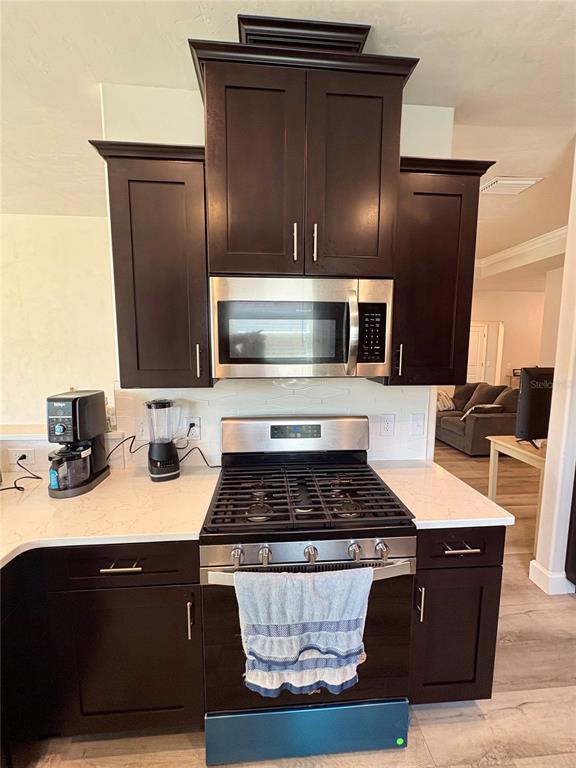 6737 Southwest 13th Lane Gainesville, FL 32607 - Photo 15 of 24 a kitchen with a sink and refrigerator