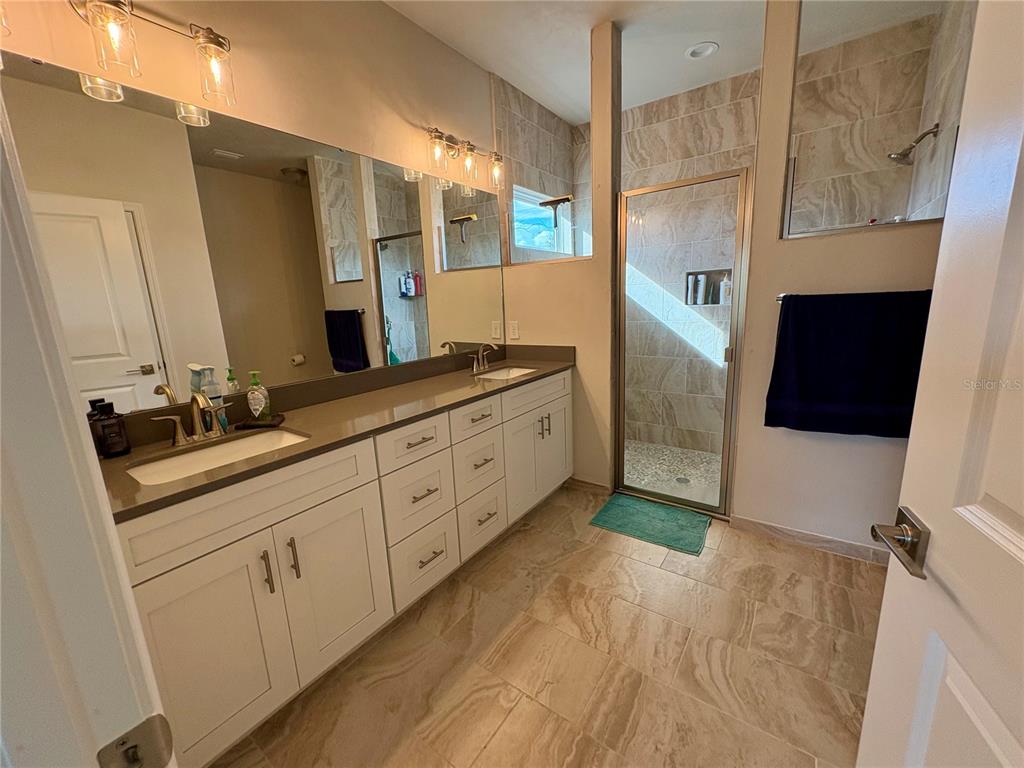 6737 Southwest 13th Lane Gainesville, FL 32607 - Photo 19 of 24 a spacious bathroom with a double vanity sink and mirror