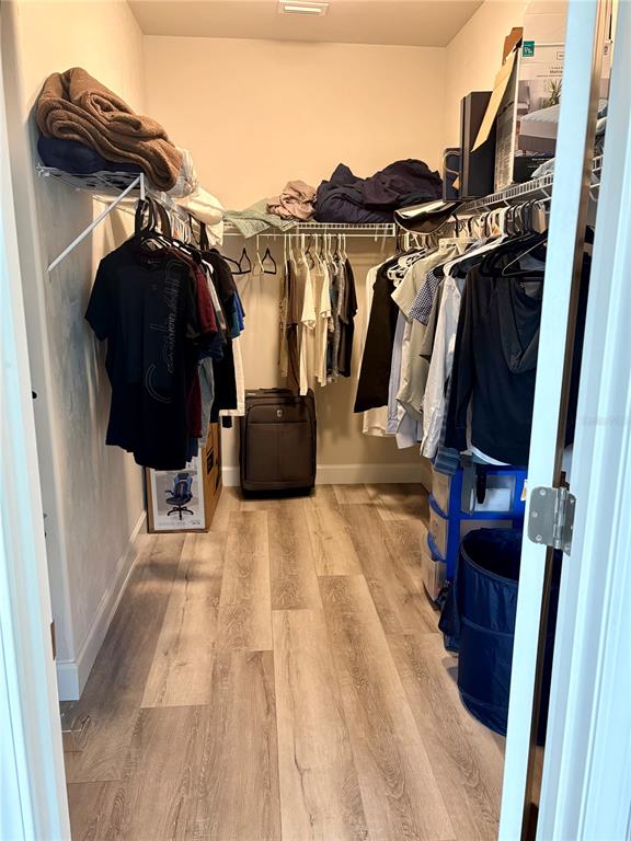 6737 Southwest 13th Lane Gainesville, FL 32607 - Photo 20 of 24 a view of walk in closet with clothes and shoes