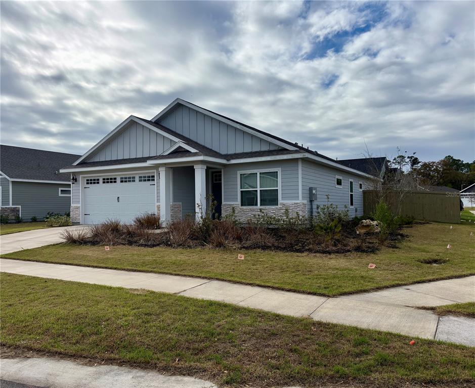 6737 Southwest 13th Lane Gainesville, FL 32607 - Photo 2 of 24 a view of a house with backyard and garden