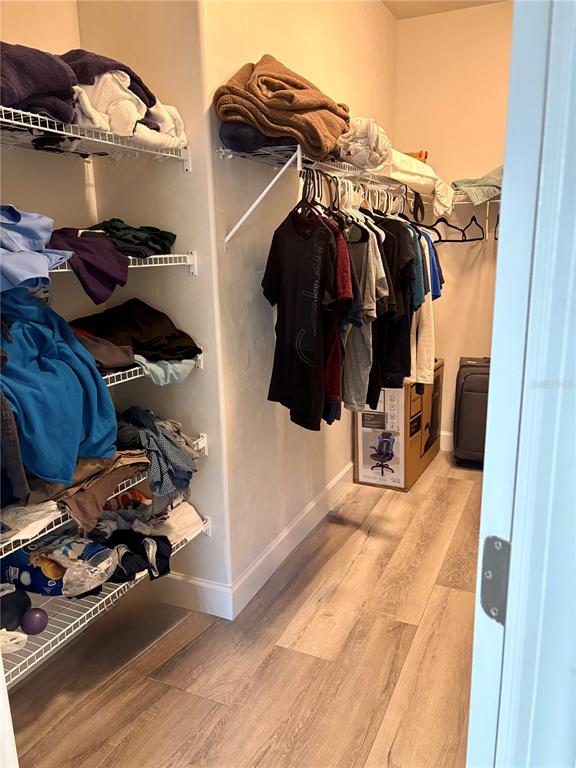 6737 Southwest 13th Lane Gainesville, FL 32607 - Photo 21 of 24 a view of walk in closet with clothes and shoes