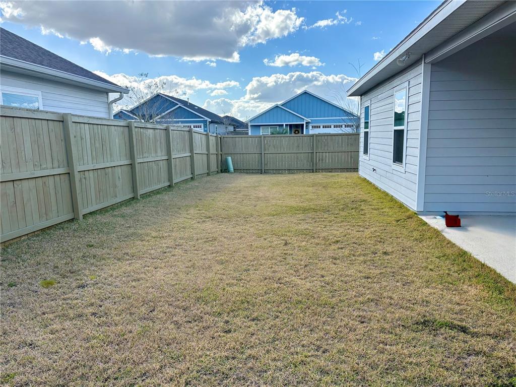 6737 Southwest 13th Lane Gainesville, FL 32607 - Photo 23 of 24 a view of a yard in front of a house with a large tree