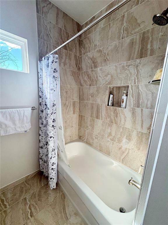 6737 Southwest 13th Lane Gainesville, FL 32607 - Photo 8 of 24 a bathroom with a bathtub and shower