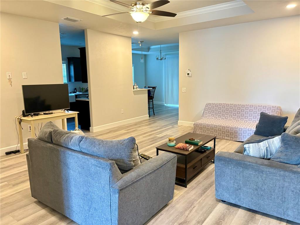 6737 Southwest 13th Lane Gainesville, FL 32607 - Photo 10 of 24 a living room with furniture and a flat screen tv