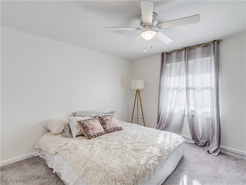 1119 Chaparrel Road Southwest Hartville, OH 44632 - Photo 7 of 23 Bedroom featuring light carpet and ceiling fan