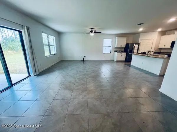a view of a kitchen with a sink and a window
