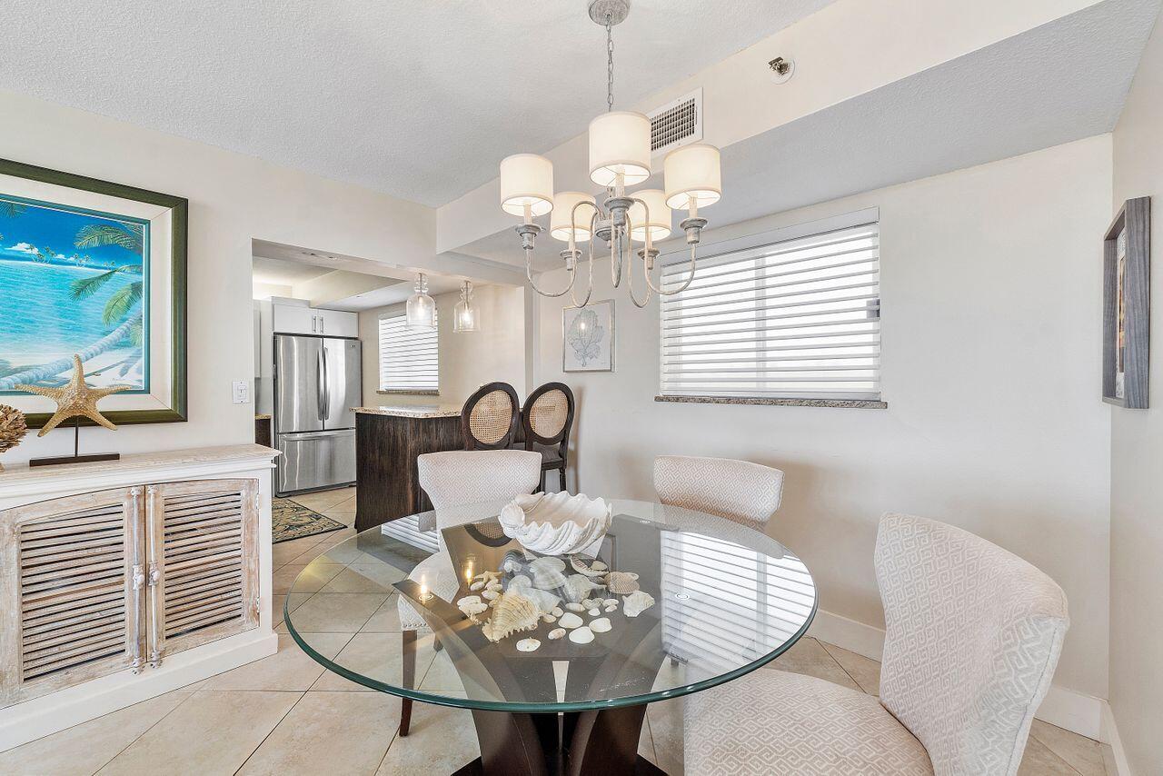 100 Ocean Trail Way, Unit 207 Jupiter, FL 33477 - Photo 11 of 61 a view of a dining room with furniture and chandelier