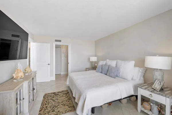 a bathroom with a granite countertop sink mirror and toilet