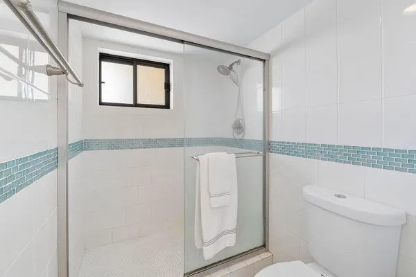 a bedroom with two beds and a night stand