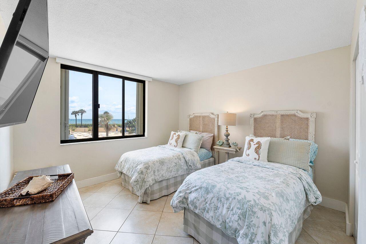 100 Ocean Trail Way, Unit 207 Jupiter, FL 33477 - Photo 25 of 61 a bedroom with two beds and a window