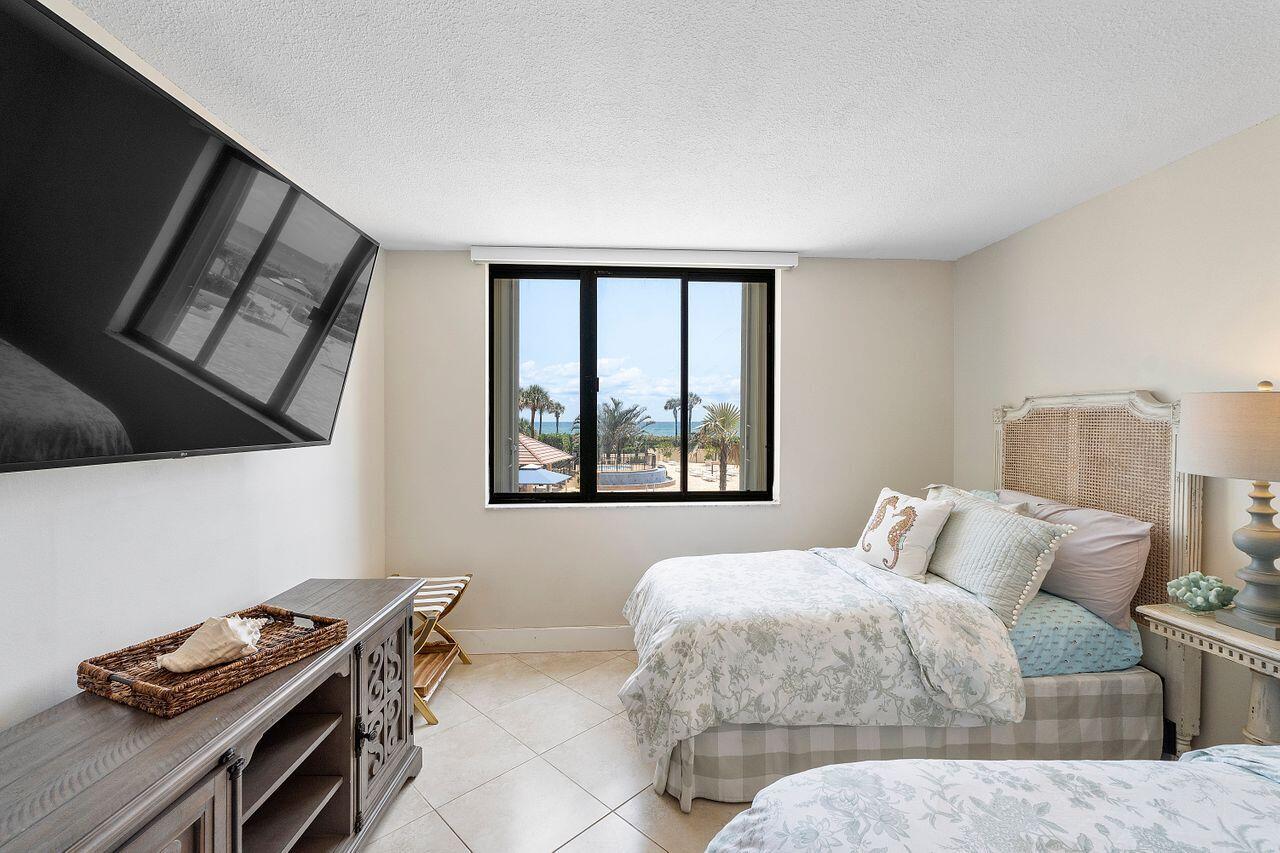 100 Ocean Trail Way, Unit 207 Jupiter, FL 33477 - Photo 29 of 61 a bedroom with a bed and a window