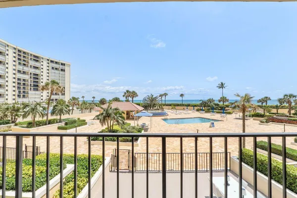 a view of a dry yard with wooden fence