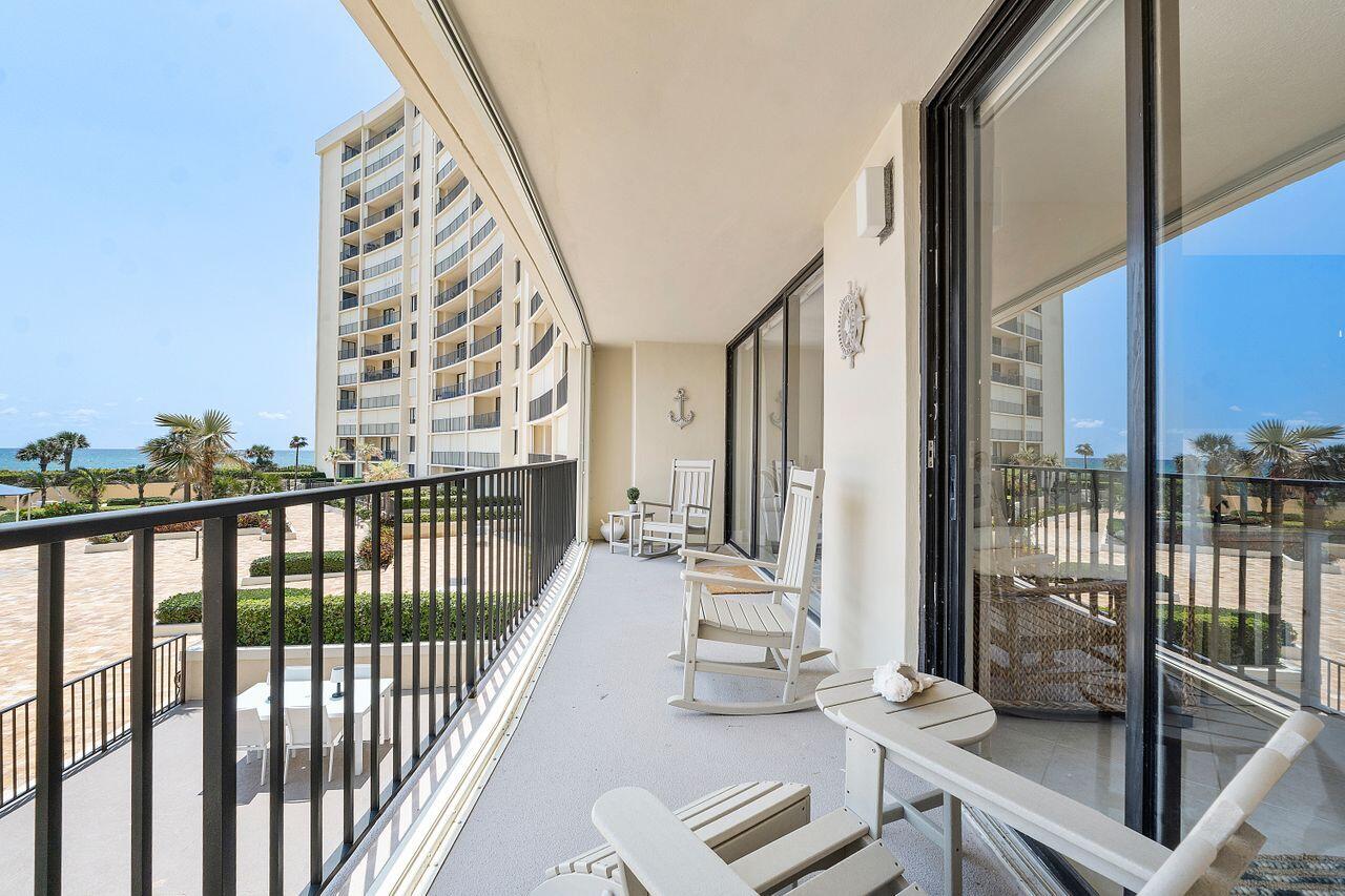 100 Ocean Trail Way, Unit 207 Jupiter, FL 33477 - Photo 37 of 61 a view of a balcony with couch and wooden floor