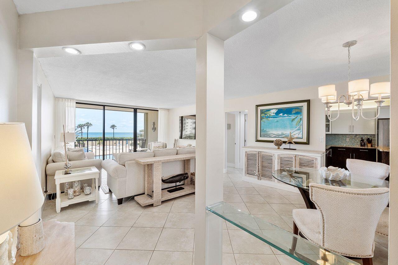 100 Ocean Trail Way, Unit 207 Jupiter, FL 33477 - Photo 5 of 61 a living room with furniture a large window and a dining table
