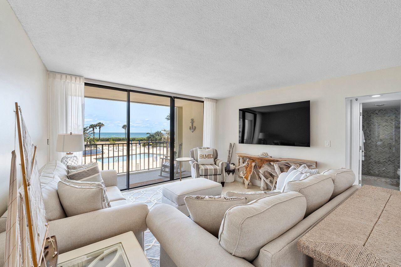 100 Ocean Trail Way, Unit 207 Jupiter, FL 33477 - Photo 6 of 61 a living room with furniture and a flat screen tv