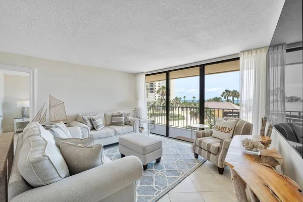 a living room with furniture a dining table and chairs