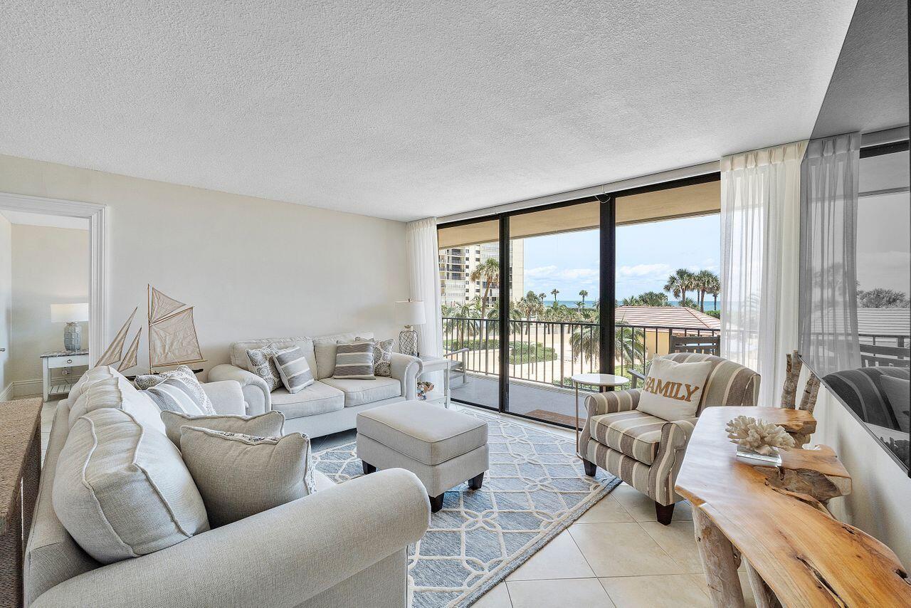 100 Ocean Trail Way, Unit 207 Jupiter, FL 33477 - Photo 7 of 61 a living room with furniture and a large window
