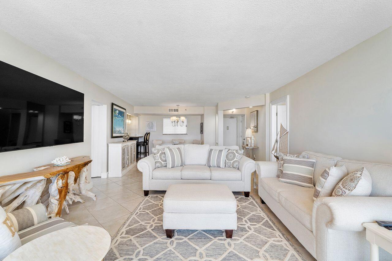 100 Ocean Trail Way, Unit 207 Jupiter, FL 33477 - Photo 8 of 61 a living room with furniture and a flat screen tv