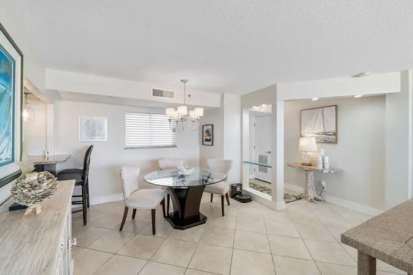 a view of a dining room with furniture and chandelier