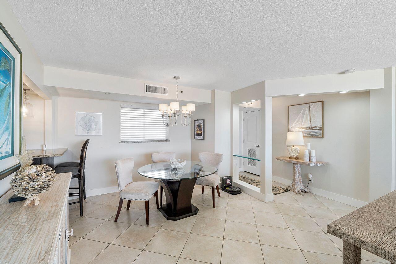 100 Ocean Trail Way, Unit 207 Jupiter, FL 33477 - Photo 9 of 61 a living room with furniture a dining table and chairs