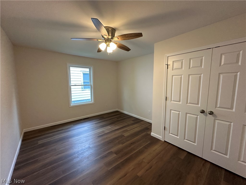 78 Prospect Street Struthers, OH 44471 - Photo 14 of 17 LTV flooring, ceiling fan with integrated lighting, white trim, and white paneled closet doors