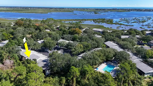 an aerial view of beach and residential houses with outdoor space