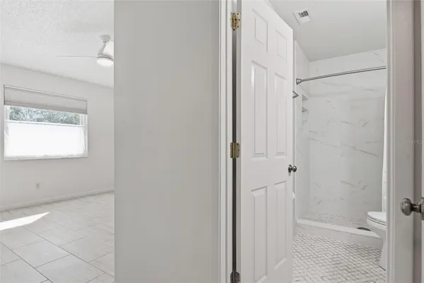 a kitchen that has a sink a window and cabinets