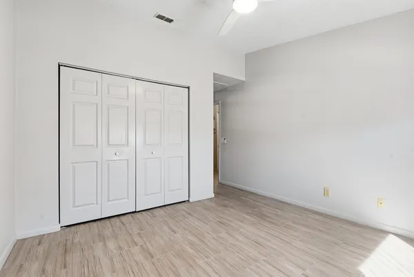 a kitchen with stainless steel appliances white cabinets and a refrigerator