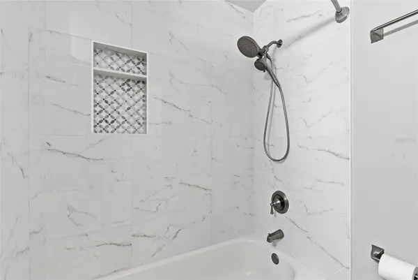 a bathroom with a granite countertop sink a toilet and shower