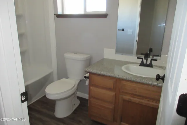 a bathroom with a sink toilet and mirror