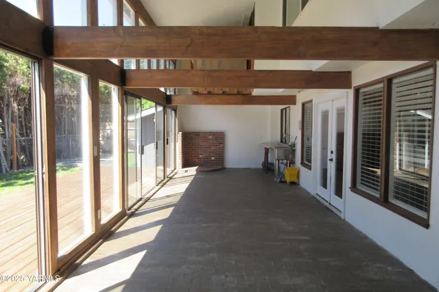 a view of a porch with furniture and front door