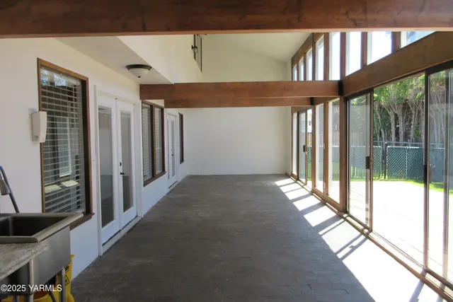a view of a pathway of a house with backyard and trees