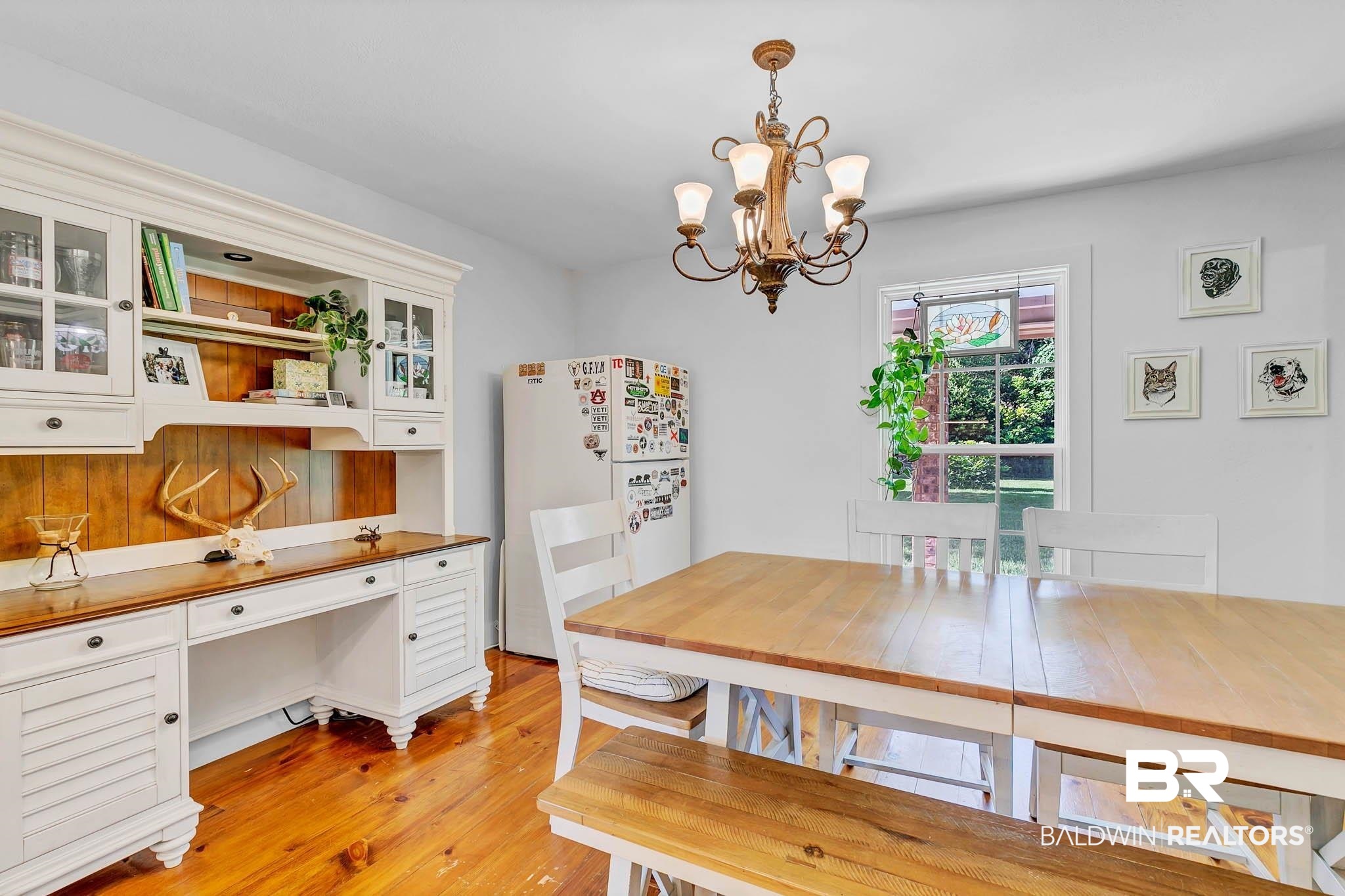 7564 Rabbit Run Road Fairhope, AL 36532 - Photo 30 of 88 Dining space featuring a chandelier and light wood-style flooring