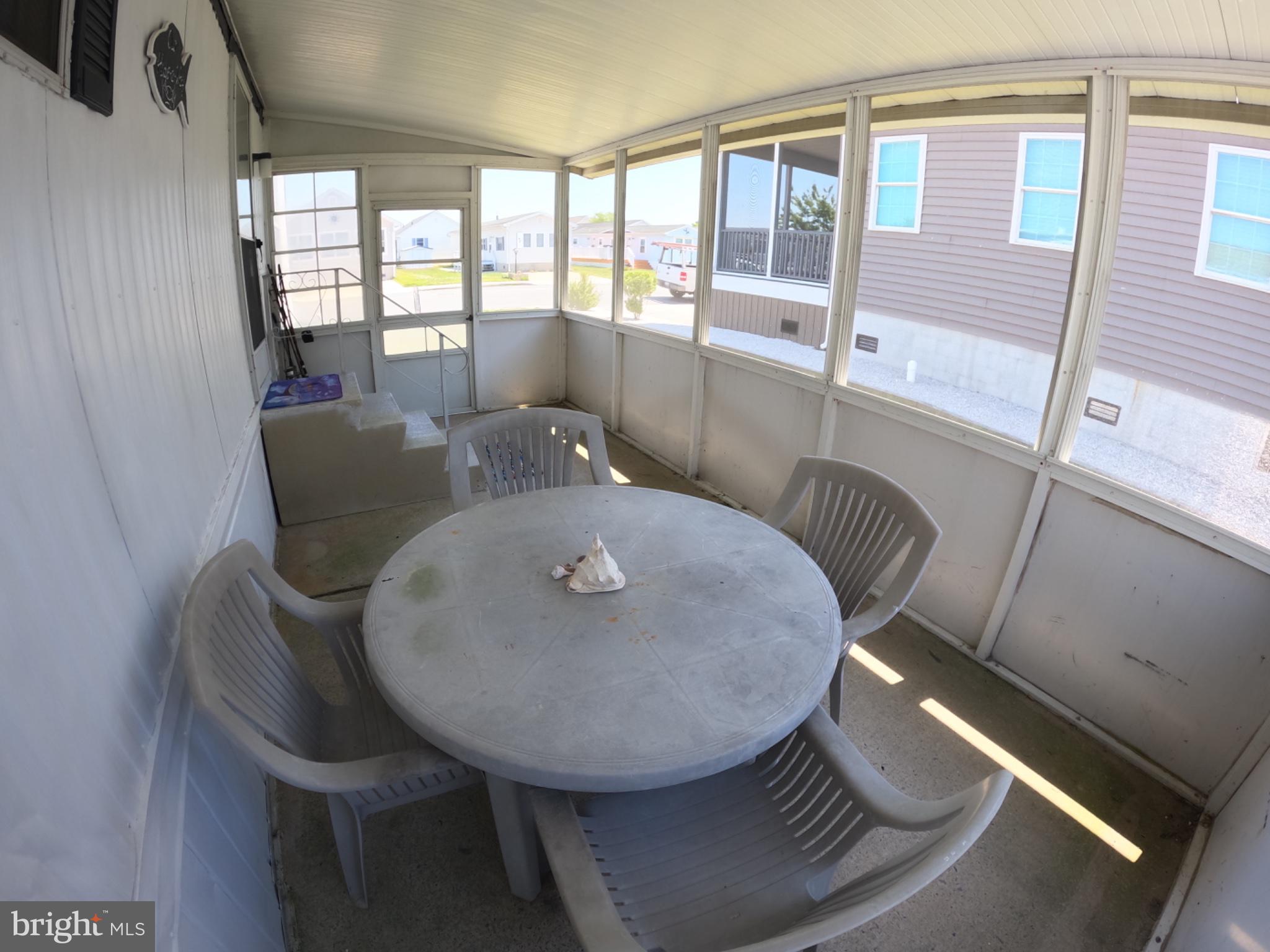 163 Clamshell Road Ocean City, MD 21842 - Photo 12 of 18 a view of a dining room with furniture window and outside view