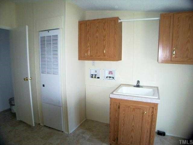 9580 Cornwall Road Oxford, NC 27565 - Photo 11 of 12 Utility room with a wash sink, cabinets, utility hookups and a large closet.
