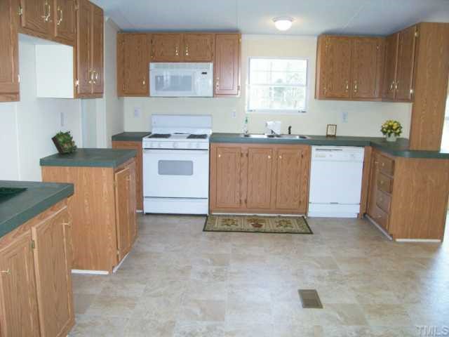 9580 Cornwall Road Oxford, NC 27565 - Photo 3 of 12 Like new kitchen with stove, builtin microwave and dishwasher.