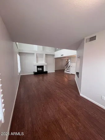 a view of a room with wooden floor and a sink