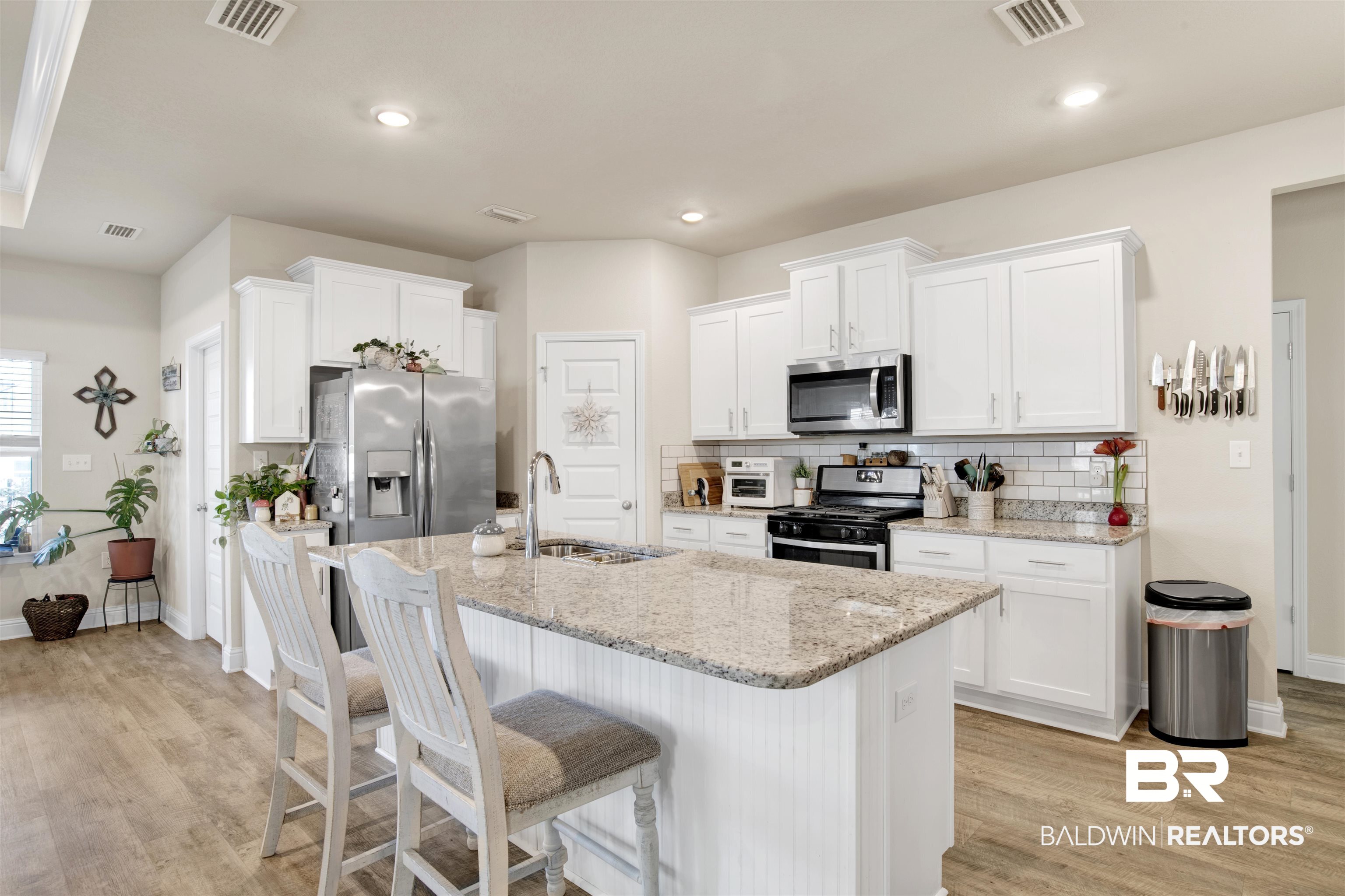 9622 Volterra Avenue Daphne, AL 36526 - Photo 6 of 31 Kitchen with light stone counters, stainless steel appliances, white cabinetry, and sink