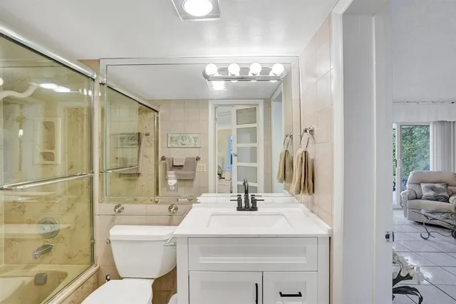 a bathroom with a sink mirror toilet and bathtub